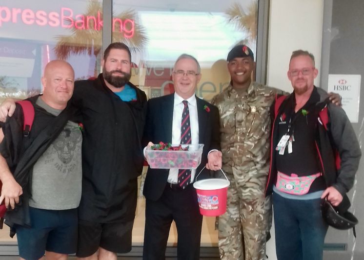Governor John Rankin and Cpl Dante Durham sell poppies to members of the Canadian team in Bermuda for the World Rugby Classic. (Photograph by RBR)